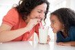 © JGI/Jamie Grill/Blend Images - Mother and daughter drinking milk
