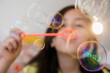 © JGI/Jamie Grill/Blend Images - Girl blowing bubbles