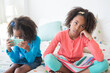 © JGI/Jamie Grill/Blend Images - Bored mixed race girl sitting on bed