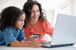 © JGI/Jamie Grill/Blend Images - Mother and daughter shopping online