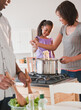 © JGI/Jamie Grill/Blend Images - African American mother and daughter preparing dinner