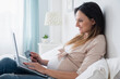 © JGI/Jamie Grill/Blend Images - Pregnant Caucasian shopping online