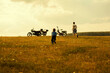 © Aliyev Alexei Sergeevich/Blend Images - Boys running to motorcycles in rural landscape