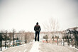 © Aliyev Alexei Sergeevich/Blend Images - Caucasian man standing on snowy roof