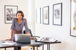 © JGI/Tom Grill/Blend Images - Black woman using laptop in art gallery office