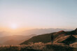 © Alexey Karamanov/Blend Images - Caucasian man admiring scenic view of sunset on mountain