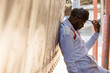 © Adam Hester/Blend Images - Serious Black man leaning on truck