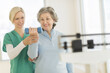© Tetra Images/Tetra Images - Mature woman exercising with personal trainer