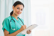 © Tetra Images/Tetra Images - Female doctor making notes