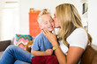 © Jessica Peterson/Tetra Images - Mother kissing son (4-5)