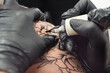 © Pixel-Shot - Professional artist making tattoo in salon