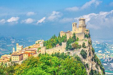 Wall Mural - Republic San Marino Prima Torre Guaita first fortress tower with brick walls on Mount Titano stone rock with green trees, aerial top panoramic view of landscape valley and hills of suburban district