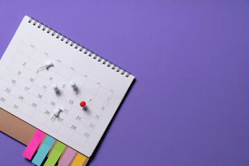 close up of calendar on the purple table background, planning for business meeting or travel planning concept