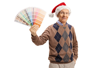 Poster - Elderly man with a santa claus hat holding a color swatch and looking at the camera