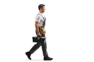 Wall Mural - Repairman in a uniform walking and carrying a tool box