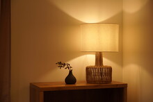 View Of A Cozy Decorative Corner With A Table Lamp Spending Warm Light