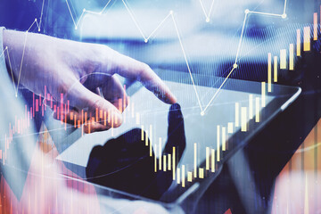 Multi exposure of man's hands holding and using a phone and financial chart drawing. Market analysis concept.