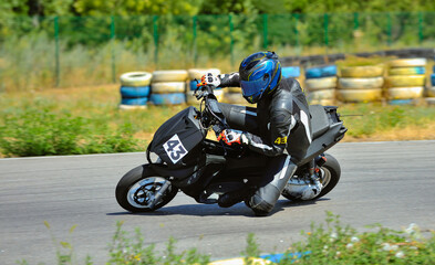 Wall Mural - Motorcycle practice leaning into a fast corner on track