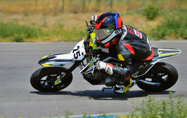 Wall Mural - Motorcycle practice leaning into a fast corner on track