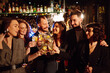 © maxbelchenko - Group of friends cheering and drinking cocktails together at the bar. Young people celebrating winter holiday together with coctails at a nightclub party. Youth, lifestyle, drink, birthday concept.