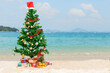 Christmas tree and gifts over beach background