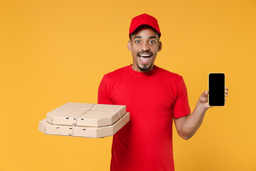 Wall Mural - Delivery employee african man in red cap blank print t-shirt uniform work courier dealer service concept hold give food order pizza cardboard boxes mobile phone isolated on yellow background studio.