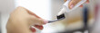 © H_Ko - Female hand squeezing toothpaste from tube onto toothbrush close-up. Daily oral care after meals concept.