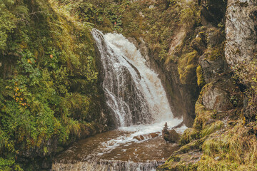 Landscape for a stunning view of the waterfall. Runoff water from mountainous areas. Unity with nature. Peaceful atmosphere