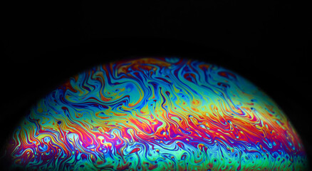 Wall Mural - macro picture of half soap bubble on black ground look like abstract psychedelic color planet in spa