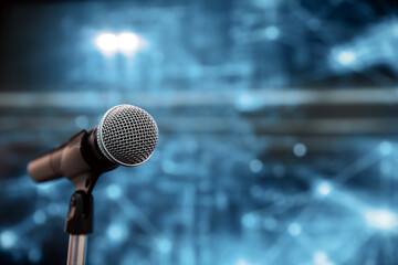 Public speaking backgrounds, Close-up the microphone on stand for speaker speech at seminar room with technology light background and blur bokeh.