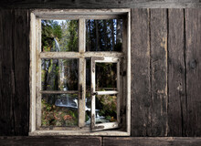 View Through A Wooden Window To A Waterfall
