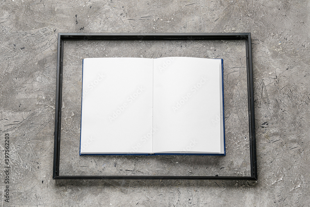 Blank book with frame on grunge background