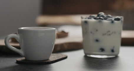 Wall Mural - espresso cup next to granola with blueberries in glass with copy space