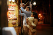 © Nomad_Soul - Couple play in shooting gallery, amusement park