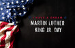Leinwandbild Motiv Happy Martin Luther King Day concept.  American flag againt black wooden background