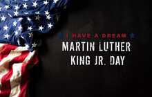 Happy Martin Luther King Day Concept.  American Flag Againt Black Wooden Background