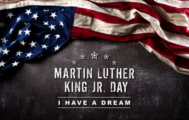 Wall Mural - Happy Martin Luther King Day concept.  American flag againt dark stone background