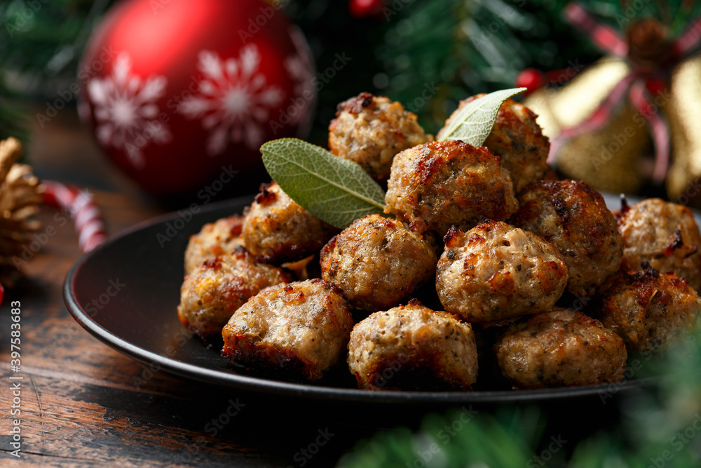 Christmas Pork stuffing meatballs with sage and onion. decoration, gifts, green tree branch on wooden rustic table - obrazy, fototapety, plakaty 