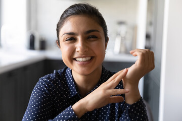 Poster - Headshot portrait of friendly mixed race woman remote employee looking at camera taking part in virtual event. Happy millennial female of indian ethnicity making videocall using home computer webcam