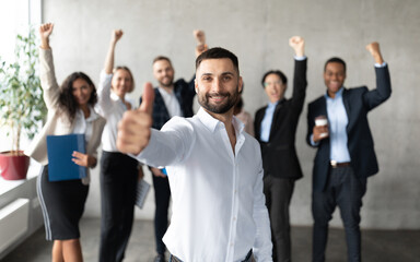 Wall Mural - Arab Businessman Gesturing Thumbs Up Standing With Employees In Office