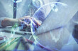 © peshkova - Double exposure of woman hands typing on computer and financial graph hologram drawing. Stock market analysis concept.