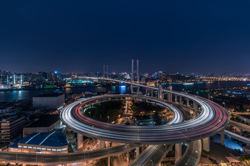 Aerial view of Nanpu Bridge at dusk, landscape of the modern Shanghai city skyline. Beautiful night view of the busy bridge across Huangpu River