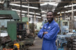 © amorn - Portrait of smiling black male engineer at work in the industry factory.
