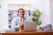 © Elnur - Young male employee in time management concept