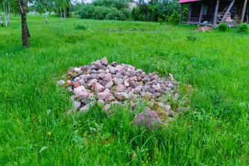 Sticker - pile of rocks pebbles in green meadow