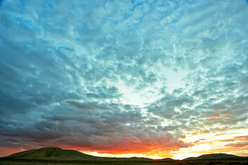 Wall Mural - Evening cloudy sky over the sand dunes.