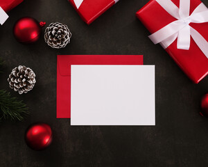 Wall Mural - blank white greeting card and envelope mockup with christmas gifts decorations on grunge background.