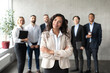 © Prostock-studio - Businesswoman Standing In Front Of Her Employees Posing In Office