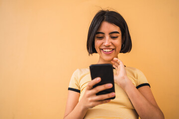 Young woman using her mobile phone.