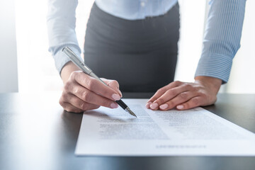 Business woman signing contract, making a deal.